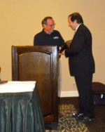 David Davidson, DPM presents the 2010 Richard Schuster Biomechanics Award to Stephen Pribut, DPM during the AAPSM Annual Membership Meeting in Seattle, Washington