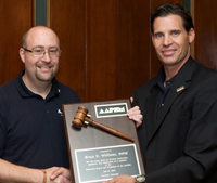 Matt Werd presents Bruce Willliams with the official AAPSM Presidential Plaque